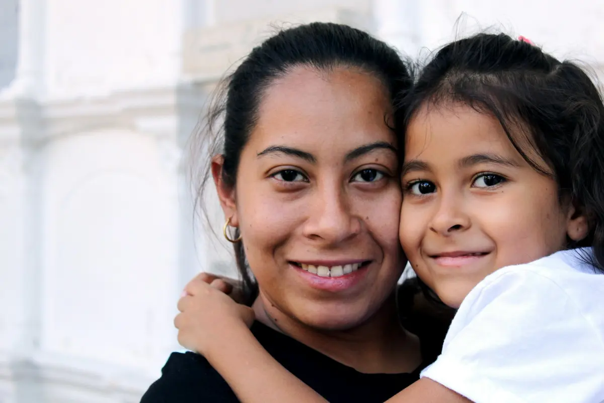 A mother and daughter, cheek to cheek